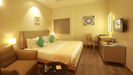 Premium Master Bedroom at Mayberry Tiruppur with a large bed, stylish furniture, and elegant decor